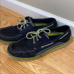 Men’s navy Sperry with lime green accents.